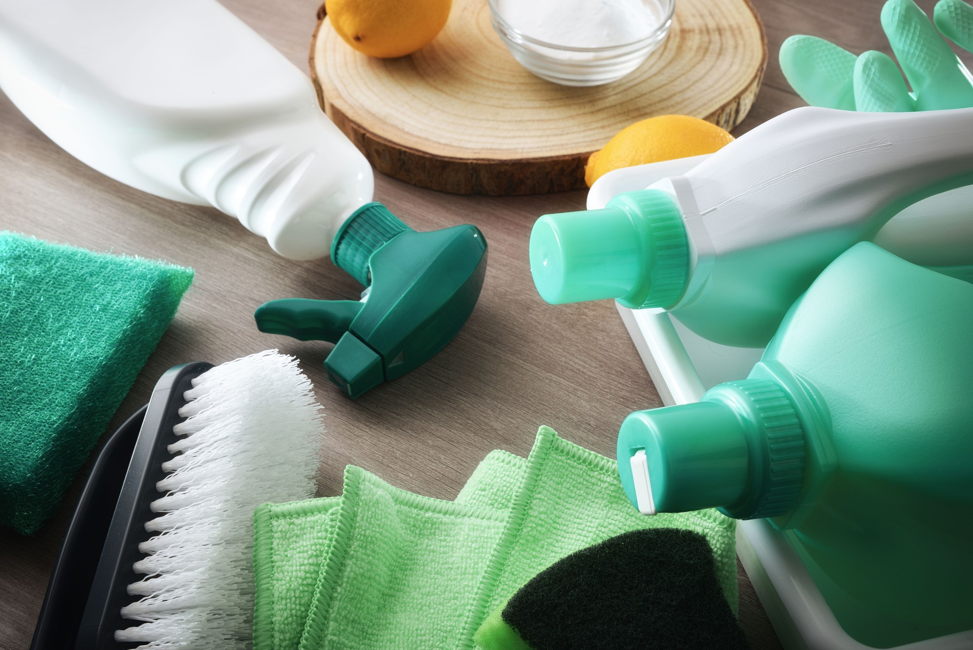 Cleaning products with natural ingredients on wooden table elevated view